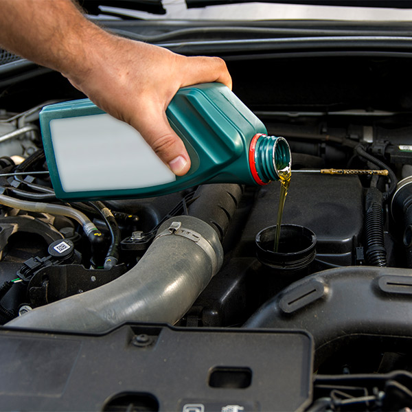 mechanic changing the car oil