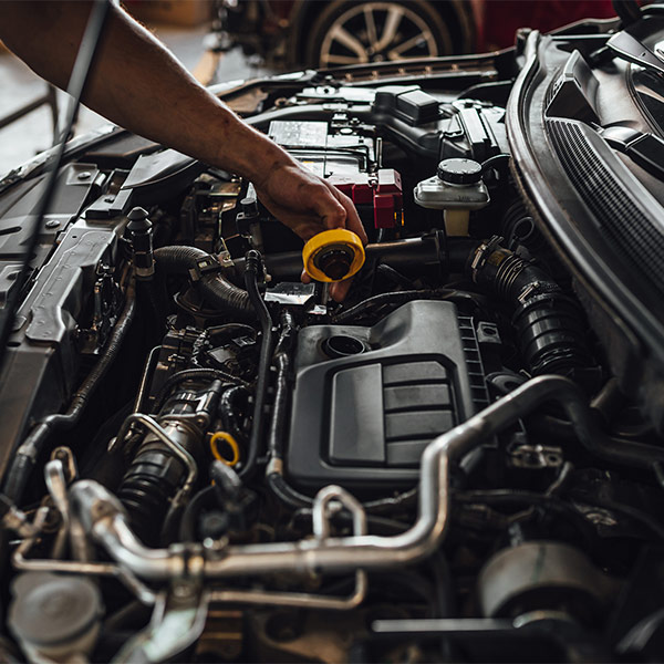 mechanic changing the car oil