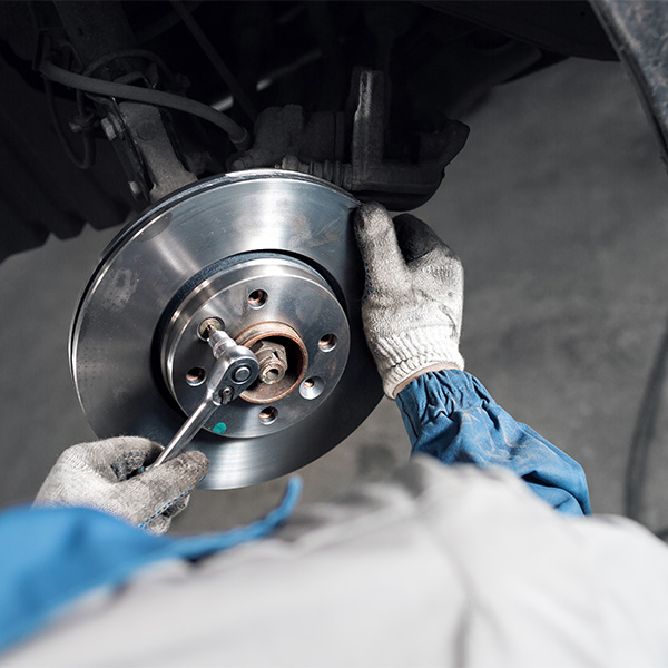 man changing the car brakes